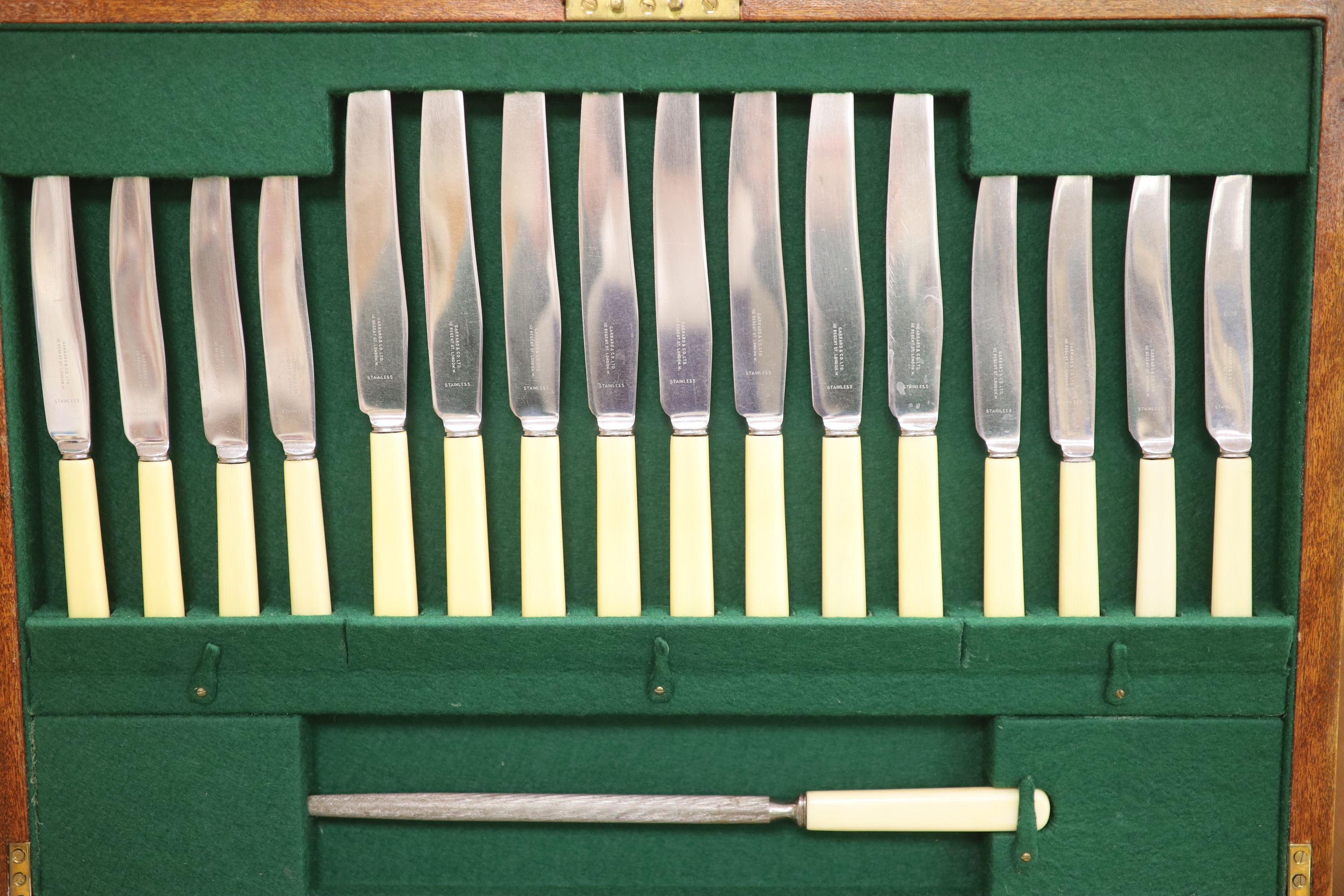 A Garrard & Co service of plated flatware in mahogany canteen, a pair of plated bottle coasters and a plated tray